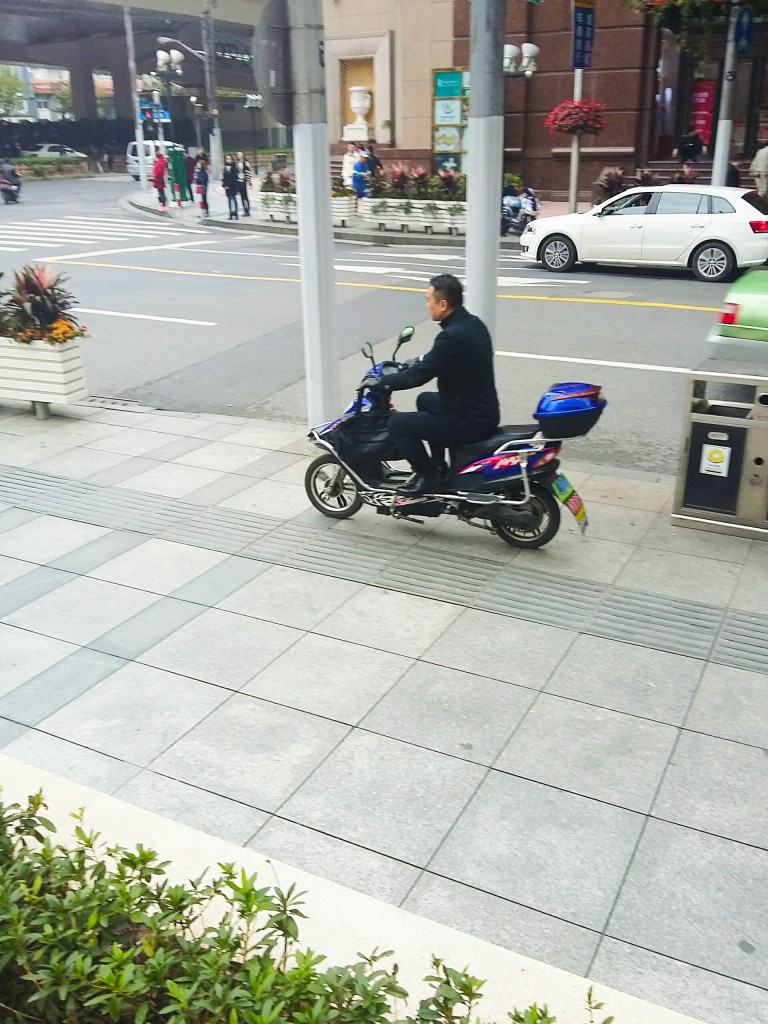 Shanghai pavement-riding scooterist