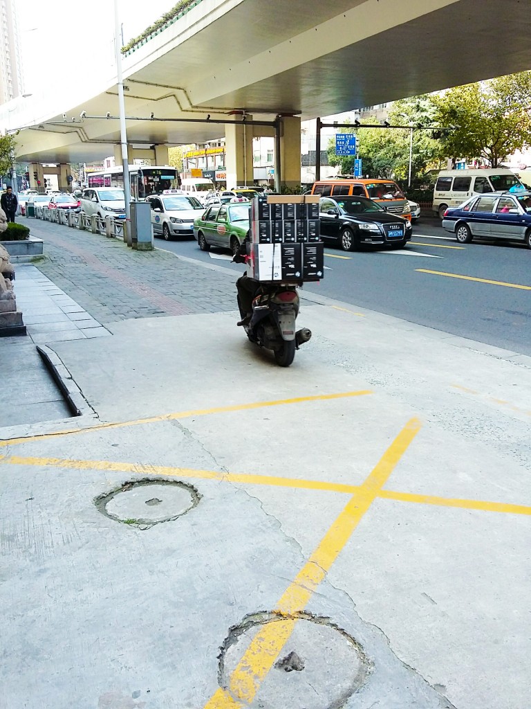 Shanghai pavement-riding scooterist